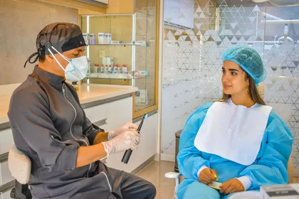 Dentist and patient discussing dental treatment options at a consultation desk in Turkey